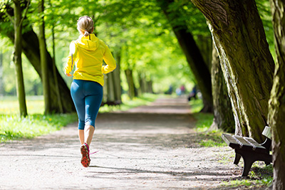 Person jogging outdoors to improve circulation, support healthy platelet count, and enhance PRP therapy results